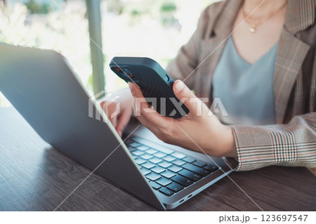 Close up female hands using smartphone shopping online, Freelancer remote working from coffee shop. Close up female hands using smartphone shopping online, Freelancer remote working from coffee shop. 123697547