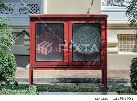 A red fire fighting equipment cabinet or Fire extinguishing cabinet (Fire hose cabinet) of fire protection set. A red fire fighting equipment cabinet or Fire extinguishing cabinet (Fire hose cabinet) of fire protection set. 123698052