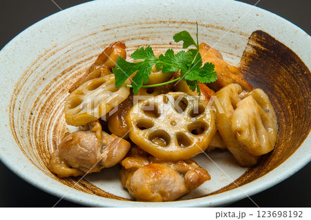 鶏肉とレンコンの甘酢炒めにパクチーを添えて 123698192