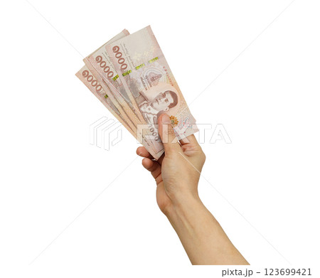 Asian woman holding Thai baht banknote money in hand isolated on white background. Asian woman holding Thai baht banknote money in hand isolated on white background. 123699421