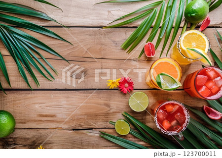 Mexican fiesta cocktails with ice cubes and lemon on wooden table with palms leaves.AI Generative. 123700011
