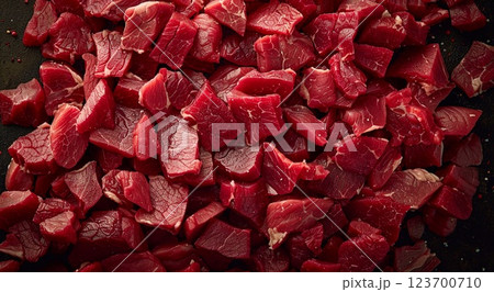 Cubed pieces of raw low fat goulash beef pieces on table wit herbs and spices.Macro.AI Generative. 123700710