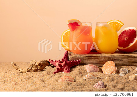 Grapefruit and orange cocktails with fresh fruits on a beach. Grapefruit and orange cocktails with fresh fruits on a beach. 123700961