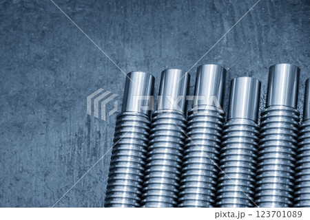 Closeup scene the spare parts lead ball screw parts in the light blue scene. Closeup scene the spare parts lead ball screw parts in the light blue scene. 123701089