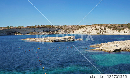Malta coastline glimmers with azure sea. Malta environment merging rocky shores, Malta perspective inviting travelers seeking breezy vantage 123701356