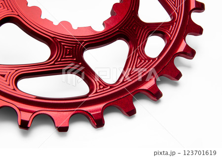Close up of a red oval bicycle chainring against white isolated background. Professional bicycle part. Close up of a red oval bicycle chainring against white isolated background. Professional bicycle part. 123701619