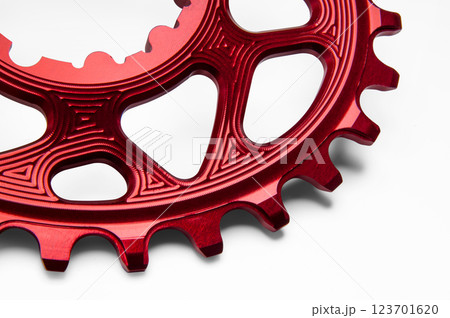 Close up of a red oval bicycle chainring against white isolated background. Professional bicycle part. Close up of a red oval bicycle chainring against white isolated background. Professional bicycle part. 123701620