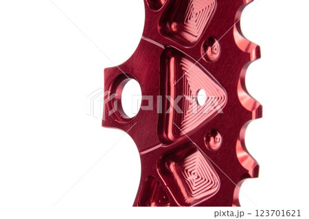 Close up of a red oval bicycle chainring against white isolated background. Professional bicycle part. Close up of a red oval bicycle chainring against white isolated background. Professional bicycle part. 123701621