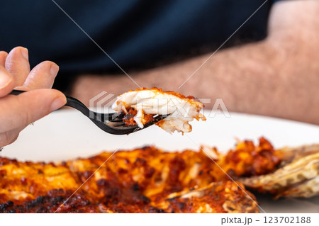 Spicy grilled grouper with a crispy charred surface, served in an Arabic restaurant in the UAE 123702188