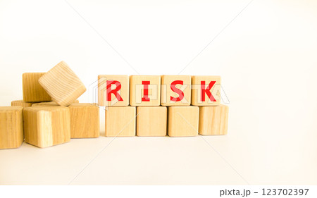Risk symbol. Concept word Risk on beautiful wooden blocks. Beautiful white table white background. Business, lifestyle, support and risk concept. Copy space. 123702397
