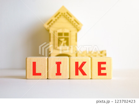Like symbol. Concept word Like on beautiful wooden blocks. Beautiful white table white background. Wooden beautiful house. Business, lifestyle, support and like concept. Copy space. 123702423