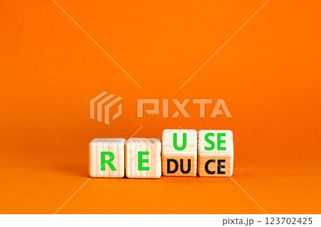 Reuse or reduce symbol. Concept words Reuse Reduce on wooden block. Beautiful orange table orange background. Business reuse or reduce concept. Copy space. Reuse or reduce symbol. Concept words Reuse Reduce on wooden block. Beautiful orange table orange background. Business reuse or reduce concept. Copy space. 123702425