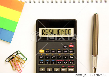 Resilience symbol. Concept word Resilience on beautiful black calculator. Beautiful white paper background. Beautiful black pen. Colored paper. Business resilience concept. Copy space. Resilience symbol. Concept word Resilience on beautiful black calculator. Beautiful white paper background. Beautiful black pen. Colored paper. Business resilience concept. Copy space. 123702480