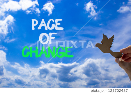 Pace of change symbol. Concept words Pace of change on beautiful blue sky. Beautiful blue sky and clouds background. Businessman hand. Wooden bird. Business pace of change concept. Copy space. Pace of change symbol. Concept words Pace of change on beautiful blue sky. Beautiful blue sky and clouds background. Businessman hand. Wooden bird. Business pace of change concept. Copy space. 123702487