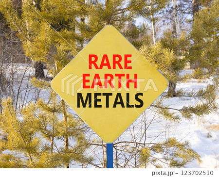 Rare earth metals symbol. Concept words Rare earth metals on beautiful yellow road sign. Beautiful winter forest background. Business and rare earth metals concept. Copy space. 123702510