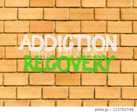 Addiction recovery symbol. Concept words Addiction recovery on beautiful brick wall. Beautiful brick wall background. Psychology addiction recovery concept. Copy space. Addiction recovery symbol. Concept words Addiction recovery on beautiful brick wall. Beautiful brick wall background. Psychology addiction recovery concept. Copy space. 123702548