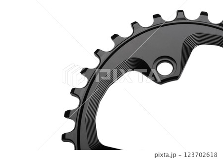 Close up of a black oval bicycle chainring against white isolated background, lies flat on the surface. Professional bicycle part. 123702618