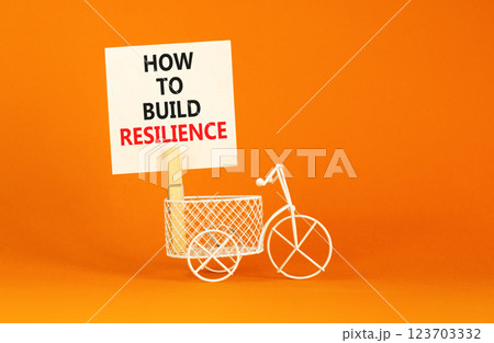 How to build resilience symbol. Concept words How to build resilience on beautiful white paper. Beautiful orange background. Miniature bicycle. Business and how to build resilience concept. Copy space How to build resilience symbol. Concept words How to build resilience on beautiful white paper. Beautiful orange background. Miniature bicycle. Business and how to build resilience concept. Copy space 123703332
