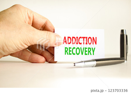 Addiction recovery symbol. Concept words Addiction recovery on beautiful white card. Psychologist hand. Beautiful white paper background. Psychology addiction recovery concept. Copy space. 123703336