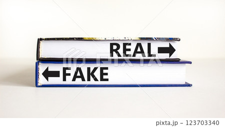 Real or fake symbol. Concept word Real or Fake on beautiful books. Beautiful white table white background. Business and real or fake concept. Copy space. 123703340