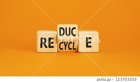 Reduce or recycle symbol. Concept words Reduce Recycle on wooden block. Beautiful orange table orange background. Business reduce or recycle concept. Copy space. 123703350