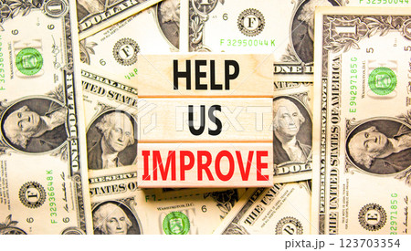 Help us improve symbol. Concept words Help us improve on beautiful wooden blocks. Dollar bills. Beautiful background from dollar bills. Business motivational help us improve concept. Copy space. Help us improve symbol. Concept words Help us improve on beautiful wooden blocks. Dollar bills. Beautiful background from dollar bills. Business motivational help us improve concept. Copy space. 123703354