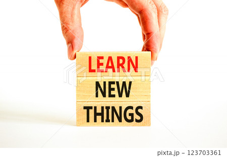 Learn new things symbol. Concept words Learn new things on beautiful wooden blocks. Beautiful white background. Businessman hand. Business motivational learn new things concept. Copy space. Learn new things symbol. Concept words Learn new things on beautiful wooden blocks. Beautiful white background. Businessman hand. Business motivational learn new things concept. Copy space. 123703361
