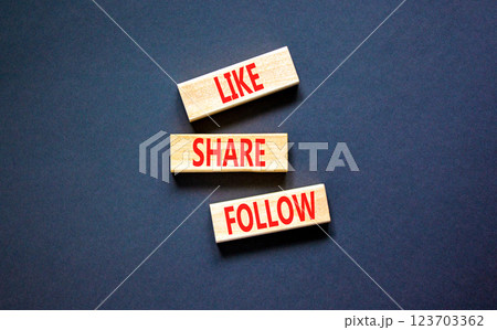 Like share follow symbol. Concept words Like Share Follow on beautiful wooden blocks. Beautiful black table black background. Business like share follow concept. Copy space. 123703362