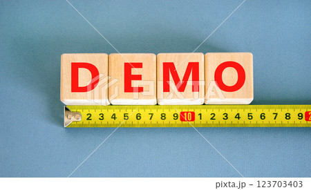 Demo symbol. Concept word Demo on beautiful wooden blocks. Beautiful yellow ruler. Beautiful blue table blue background. Business and demo concept. Copy space. 123703403