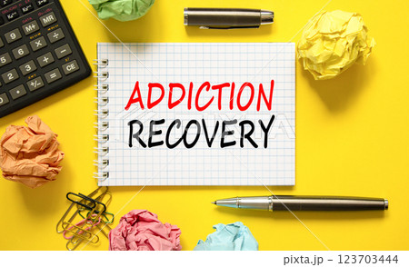 Addiction recovery symbol. Concept words Addiction recovery on beautiful white note. Black calculator. Colored paper. Beautiful yellow background. Psychology addiction recovery concept. Copy space. 123703444