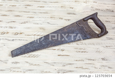Hand tool. Hacksaw on wood lies on a wooden background Hand tool. Hacksaw on wood lies on a wooden background 123703654