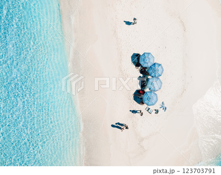 Aerial view of seascape atoll sandbank island with beach umbrellas in Maldives Aerial view of seascape atoll sandbank island with beach umbrellas in Maldives 123703791