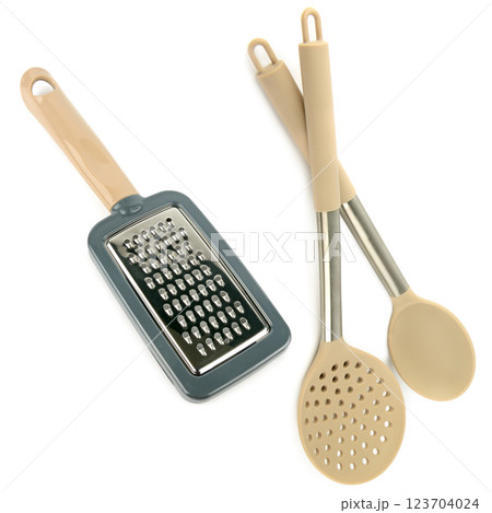 Grater, kitchen spoon and slotted spoon isolated on white. Collage. Grater, kitchen spoon and slotted spoon isolated on white. Collage. 123704024