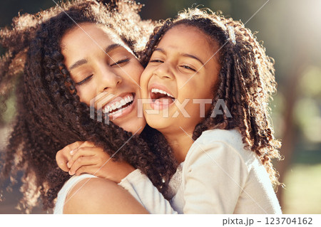 Happy girl kid hugging mom for mothers day, love and relax at park outdoors for fun together in Colombia. Smile parent, laughing child and play for happiness, quality time and care in summer garden Happy girl kid hugging mom for mothers day, love and relax at park outdoors for fun together in Colombia. Smile parent, laughing child and play for happiness, quality time and care in summer garden 123704162