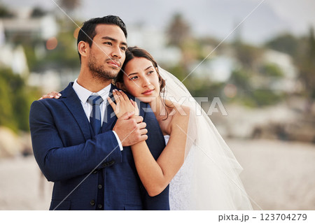 Wedding, love and couple hug by beach for commitment, care or bonding together. Thinking, travel and groom with bride for embrace with sea view at romantic, tropical and destination ceremony by ocean 123704279