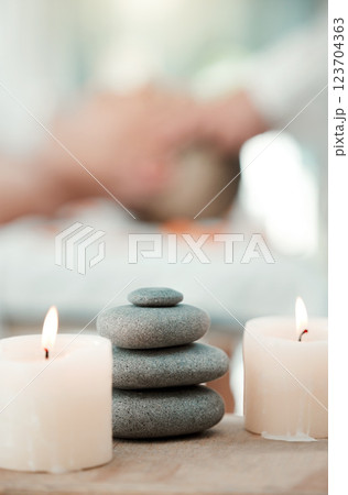 Spa, rock and candle to relax in a room with atmosphere, mood or ambience in a health club. Wellness, luxury and treatment with still life objects on a table in a clinic for rest and relaxation Spa, rock and candle to relax in a room with atmosphere, mood or ambience in a health club. Wellness, luxury and treatment with still life objects on a table in a clinic for rest and relaxation 123704363