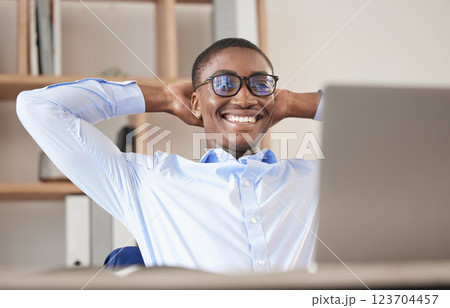 Black man, relax and laptop in office break, social media or web browsing after successful business deal. Leader, ceo or manager in Nigeria resting after writing email or planning finance strategy. 123704457