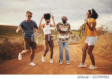 Friends dance, travel and freedom adventure on a nature dirt road jump for fun and joy outdoor. Diversity of people and travelers happy about free and summer holiday laughing together in desert 123704462