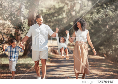 Family, happy and park summer fun of a father, mother and children swinging on a nature path. Happiness of parents holding hands with kids together with love, smile and support outdoor walking Family, happy and park summer fun of a father, mother and children swinging on a nature path. Happiness of parents holding hands with kids together with love, smile and support outdoor walking 123704481