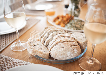 Sourdough bread, food and lunch meal for fine dining, eating and dinner table in house, restaurant and cafe. Closeup slice of wheat grain baguette, nutrition and artisan rye on plate enjoy with wine 123704604