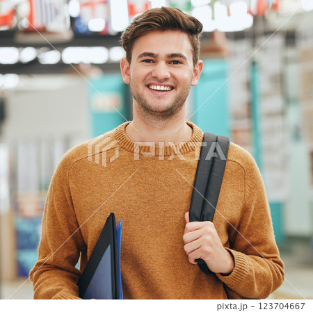 College, study and education student man portrait with back to school backpack and portfolio in a classroom or university campus. Learning person with motivation, goal and knowledge for a scholarship 123704667