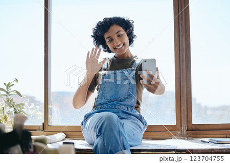 Phone, selfie or video call with a woman on social media while sitting on a table by a window inside with a wave. Communication, networking and internet with a young female using wifi technology 123704755