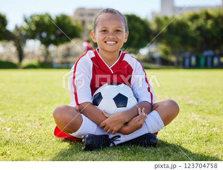Sports, happy and girl. relax on soccer field after game, competition or fitness cardio exercise. Sitting, kid child or young athlete with smile after youth football, practice or training workout 123704758