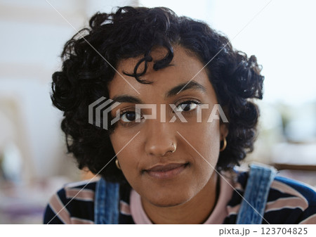 Face, eyes and portrait with a woman from India closeup inside with curly hair and a serious expression. Head, nosering and piercing with an attractive young female for edgy, trendy or modern style Face, eyes and portrait with a woman from India closeup inside with curly hair and a serious expression. Head, nosering and piercing with an attractive young female for edgy, trendy or modern style 123704825