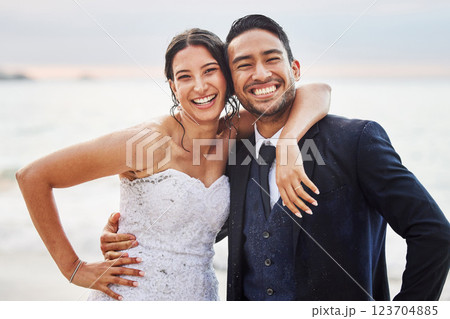Wedding, happy and portrait of couple by beach for commitment, care or bonding together. Sea, travel and groom with bride for hug at romantic, tropical and destination marriage ceremony by ocean Wedding, happy and portrait of couple by beach for commitment, care or bonding together. Sea, travel and groom with bride for hug at romantic, tropical and destination marriage ceremony by ocean 123704885