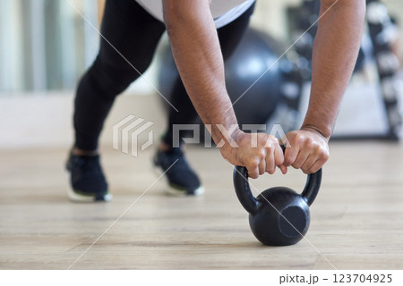 Hands, fitness and kettlebell in gym, training and person with equipment for exercise and wellness. Health club, core strength and bodybuilding with grip, balance and athlete with coordination Hands, fitness and kettlebell in gym, training and person with equipment for exercise and wellness. Health club, core strength and bodybuilding with grip, balance and athlete with coordination 123704925