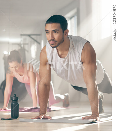 Athlete, man and push up for fitness at gym with exercise, core strength and body balance. Male person, plank and muscle training for endurance, cardio performance and sports workout of wellness goal 123704979