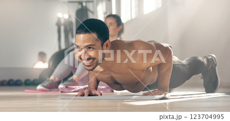 Fitness, push up and smile with shirtless man in gym for physical conditioning, training or workout routine. Body, exercise and strength with happy athlete in health club for challenge or performance Fitness, push up and smile with shirtless man in gym for physical conditioning, training or workout routine. Body, exercise and strength with happy athlete in health club for challenge or performance 123704995