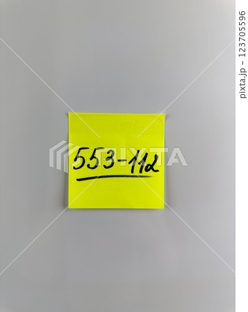 Vertical photo of phone number written on sticky note Vertical photo of phone number written on sticky note 123705596