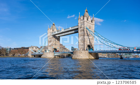 Tower Bridge stands majestically against a clear blue sky in London. The sunlight highlights its unique architecture and the flowing river beneath showcases a perfect day for exploration. Tower Bridge stands majestically against a clear blue sky in London. The sunlight highlights its unique architecture and the flowing river beneath showcases a perfect day for exploration. 123706585